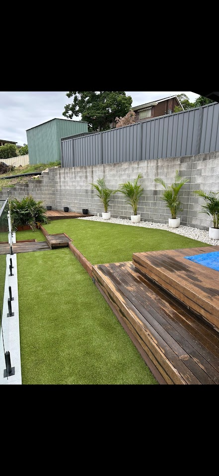 Residential synthetic grass installation with timber decking