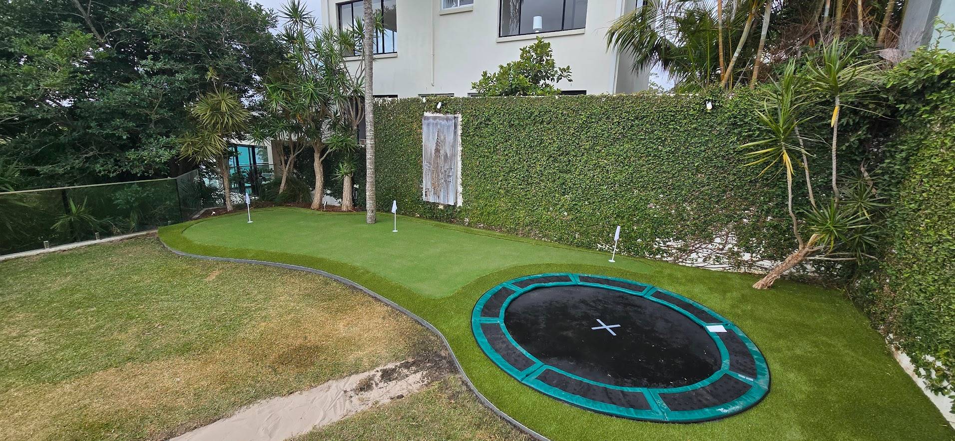 Luxury property with synthetic golf green and in-ground trampoline