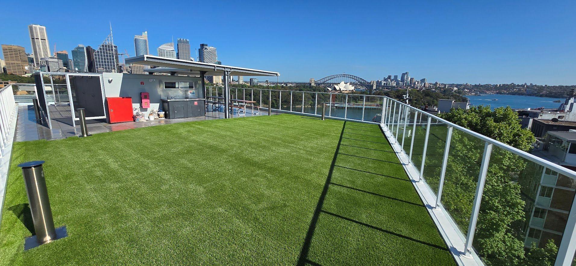 Commercial rooftop synthetic grass installation overlooking Sydney Harbour